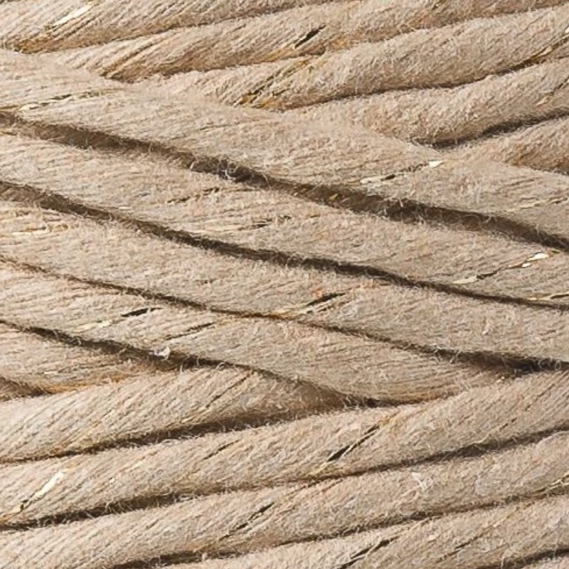 Close-up of beige twisted rope with golden flecks